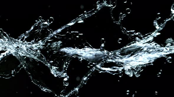 Super Slow Motion Shot of Swirling and Splashing Water Isolated on Black Background at 1000Fps