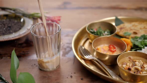 Beautiful and Homemade Fresh Indian Sri Lankian Drink - Mango Lassi. On Wooden Table, Garnished with