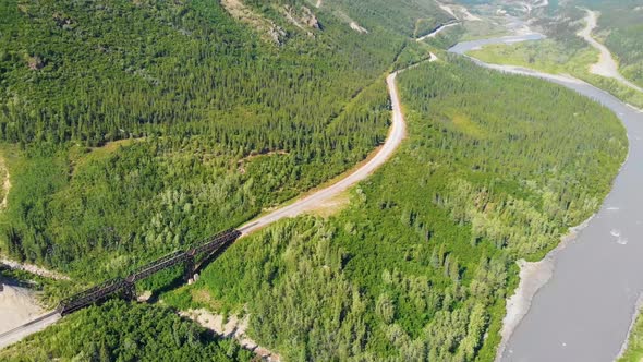 4K Drone Video of Train Trestle bridge and Mountains Rising above the Chulitna River near Denali Nat