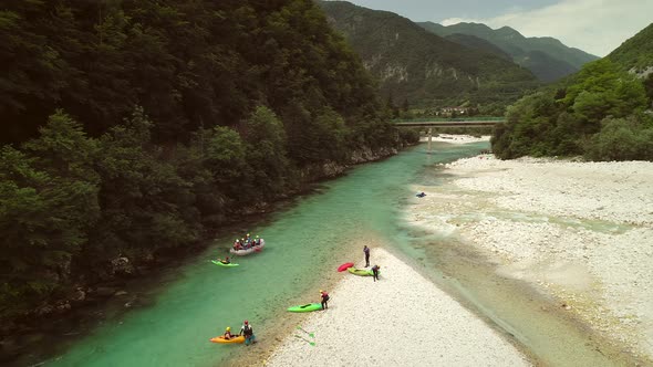 Aerial view of rafters doing rafting in turquoise water going down at Soca river