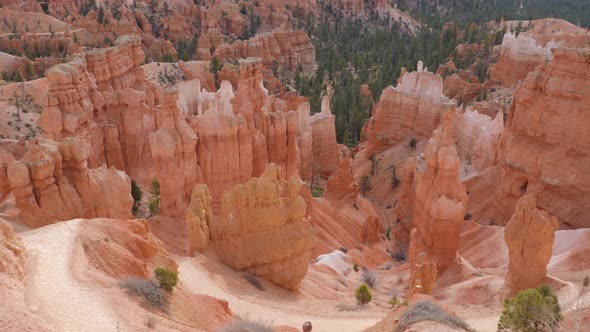 Slow motion shot of female hiker walking on trail in Bryce Canyon National Park in Utah, USA camera