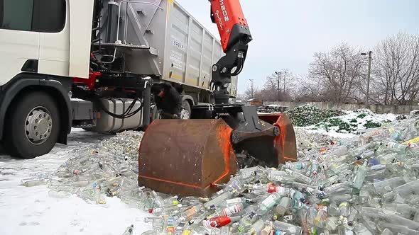 A Large Bucket Grips The Glass Bottles