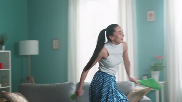 Energetic Woman Has Fun Cleaning Apartment