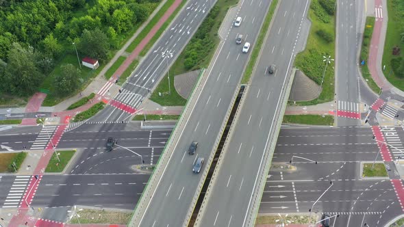 Aerial top down view of interchange road junction traffic. Drone shot flying