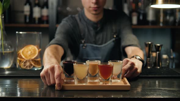 Beautiful Row Line of Different Colored Alcohol Cocktails Bartender on a Party Martini Vodka