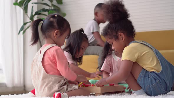 Children playing with their friends, Little girls and boy mould from plasticine on the floor