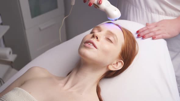 in a Modern Spa, a Cosmetologist Performs a Hardware Lift on a Woman's Face