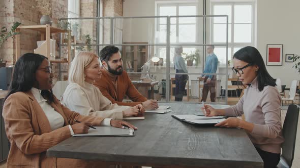 Female Job Candidate Singing Contract at Job Interview