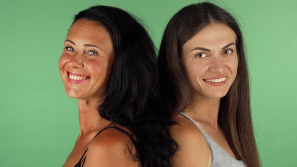 Two Gorgeous Women Smiling Joyfully To the Camera