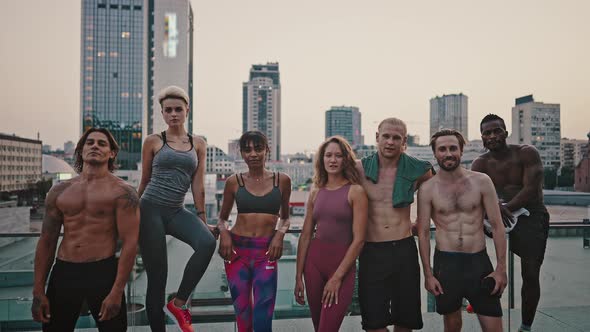 Close Up Outdoor Portrait of a Team of Active Attractive Men and Women in Sportswear Against the