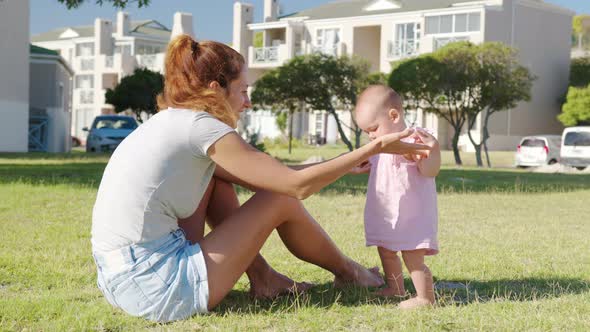 Happy Moms and Baby on a Walk in the Park