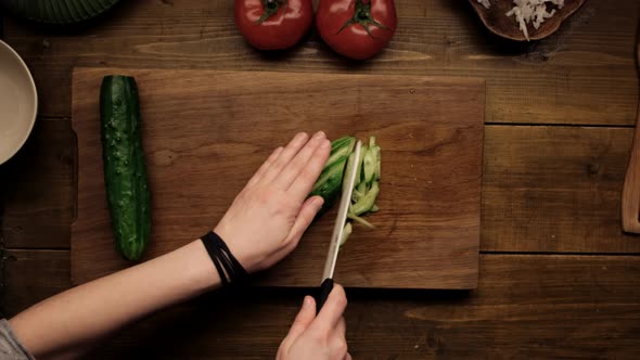 Top View  Female Cuts the Cucumber