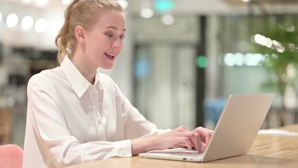 Beautiful Businesswoman Celebrating Success on Laptop