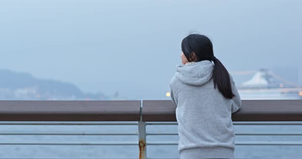 Woman look at the harbor front in the city