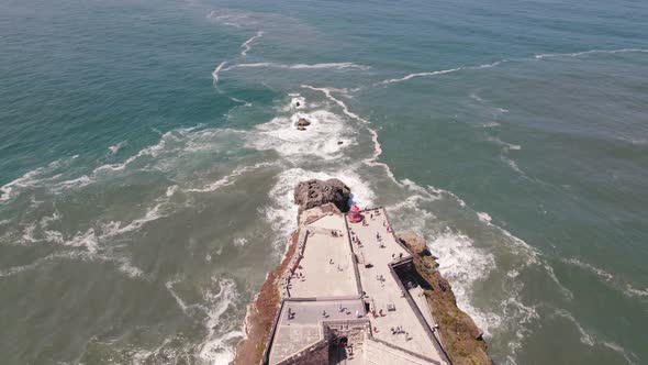 People visiting Lighthouse and Fortress of Saint Michael the Archange in Nazare, Portugal