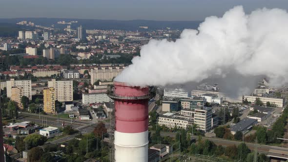 Aerial view of high chimney pipe with white smoke from coal power plant