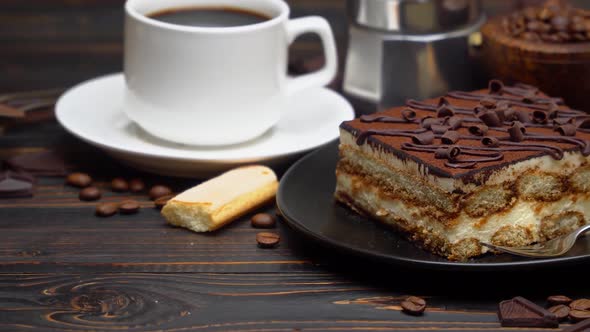 Portion of Traditional Italian Tiramisu Dessert Cup of Espresso Mocha and Coffee Beans