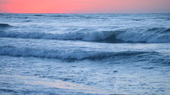 Dark Blue Sea Water of the Ocean Against the Background of the Red Dawn