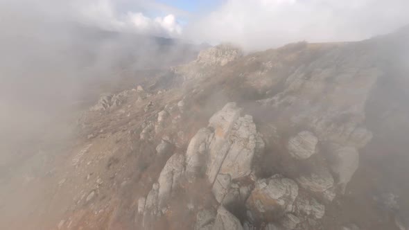 Shooting From Sports Fpv Drone Flying Over Mount Katyusha with Dense Natural Fog Over City