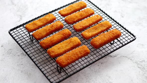 Rows of Golden Fried Fresh Fish Fingers Fillets