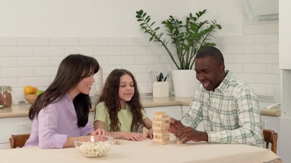 Cheerful Multi Ethnic Family Playing Board Game at Home