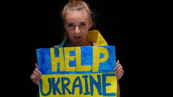 Portrait of Brave Confident Ukrainian Woman Talking Looking at Camera Showing Help Ukraine Placard