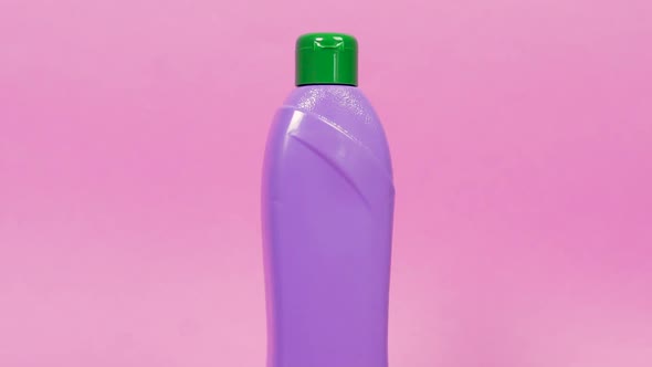 A Purple Plastic Jar of Cleaning Agent a Cleaning Cloth and a Cleaning Brush