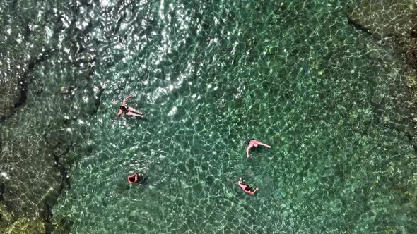 People swim in the azure sea aerial view 4 K