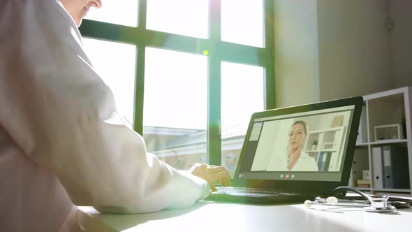 Doctor with Laptop Having Video Call at Hospital