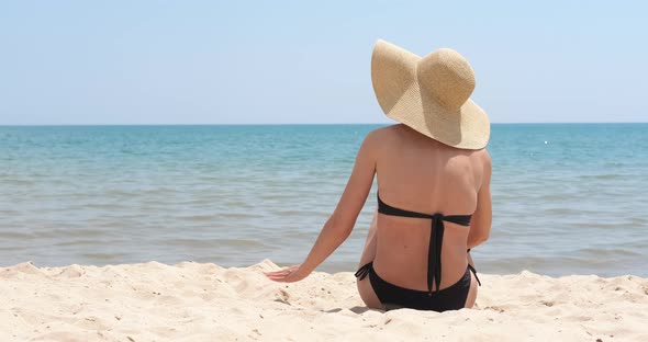 Woman relaxing time on shore.