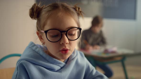 Schoolgirl Talking at Lesson in Classroom