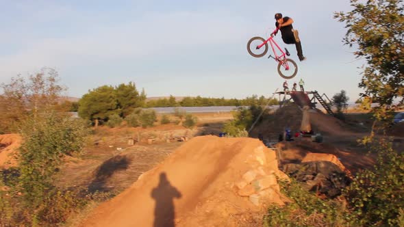 A young man riding a BMX bicycle.