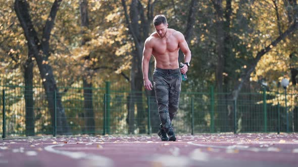 Muscular sportsman outdoors. 