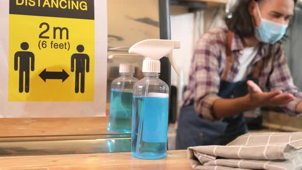 Sanitizer in front of a male barista, waiting for order in COVID19 quarantine.