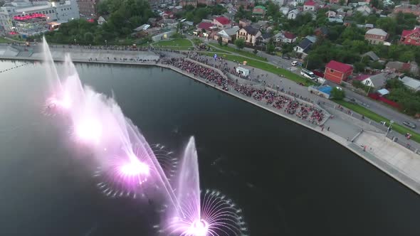 Beautiful Dancing Fountain. Aerial shot of the colorful illuminated musical fountain at dusk