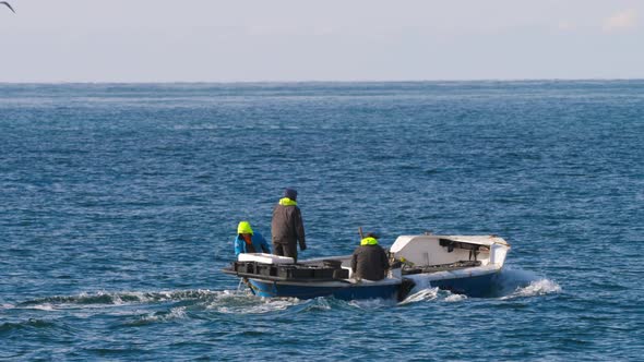 Fishermen Going To the Sea on a Motor Boat