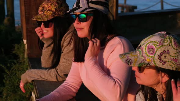 group of cheerful women looking at the sea with cap, pichilemu, punta de lobos, surf beach.Chile.