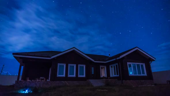 Night Timelapse with a Beautiful House the Movement of Stars and Clouds in the Night Sky