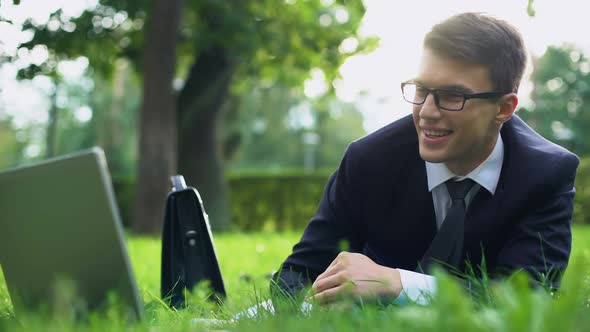 Happy Businessman Lying on Grass and Relaxing After Hardworking, Inner Harmony