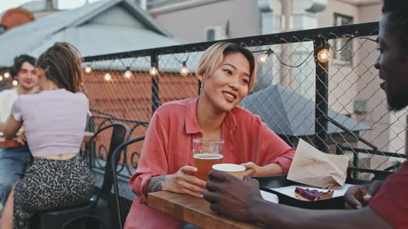 Multiethnic Couple on Date at Rooftop Bar