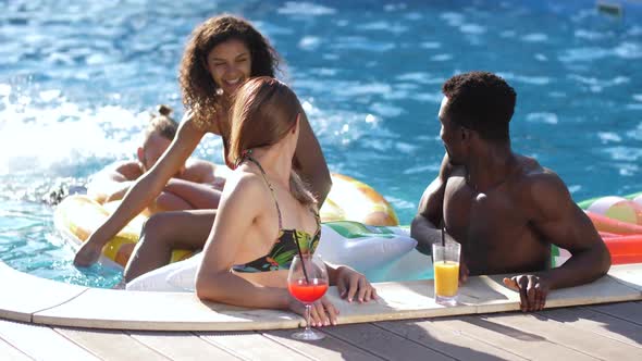 Cheerful Diverse Friends Chatting Near Pool Side