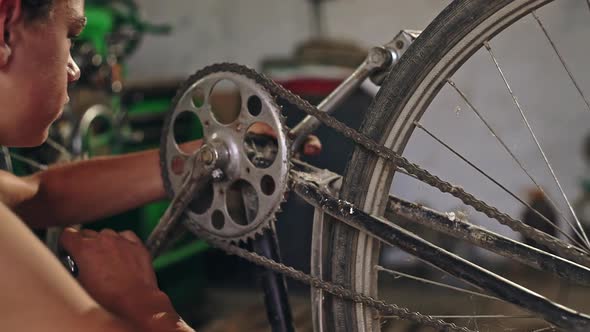 Young Boy Is Very Concentrated Repairing a Flat Tire on His Bicycle All By Himself  Slwo Motion