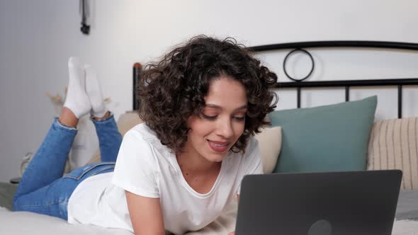 Smiling Hispanic Curly Woman Student Study Uses Laptop Distance Education