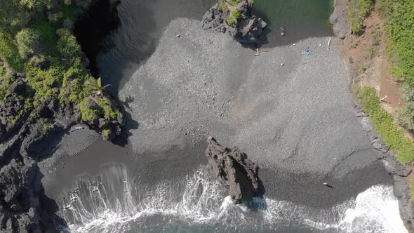 Beautiful relaxing 4k drone shot in Maui south east of Hana. Hidden black sand beach and lagoon. Fri