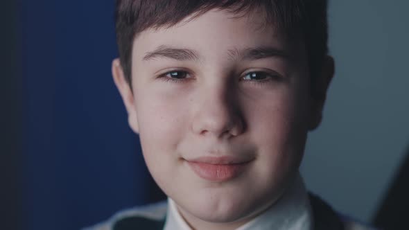 Closeup Portrait of Cute Boy 13 Years Old Looking at Camera While Sitting at Computer Laptop at Home