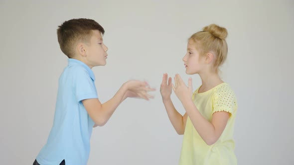 Two Children are Arguing the Girl and the Boy are Arguing and Gesturing with Their Hands