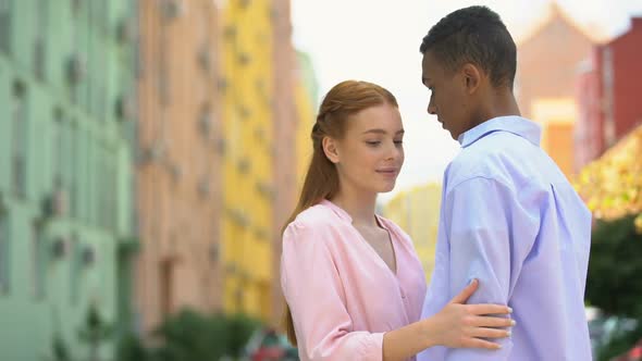 Young Multiracial Girlfriend and Boyfriend Tenderly Hugging Meeting Each Other