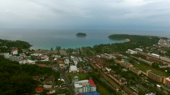 Drone Flying in the Blue Cloudy Sky Over the Sea Coast