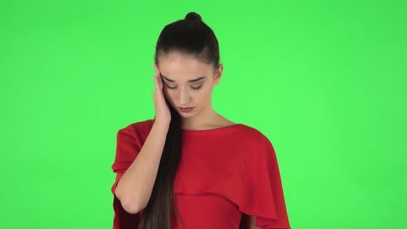 Portrait of Pretty Young Woman Is Suffering From Headache From Fatigue. Green Screen