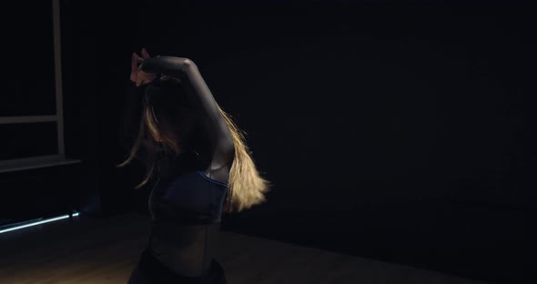 Gorgeous Young Woman Is Dancing in Low Light of the Gym at Night Film Grain